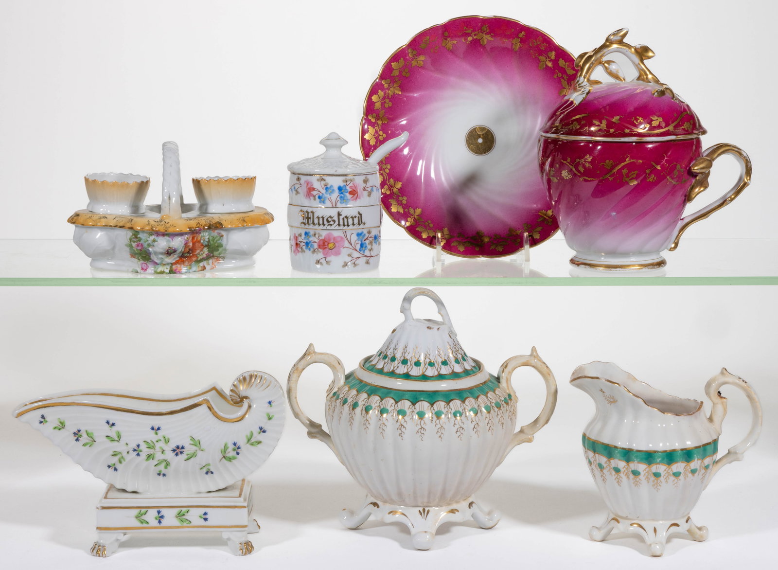 ASSORTED CERAMIC ARTICLES, LOT OF SEVEN: ASSORTED CERAMIC ARTICLES, LOT OF SEVEN, comprising a large covered mush cup with molded vine handle and finial and a saucer, each having crimson ground and featuring gilt transfer ivy and b