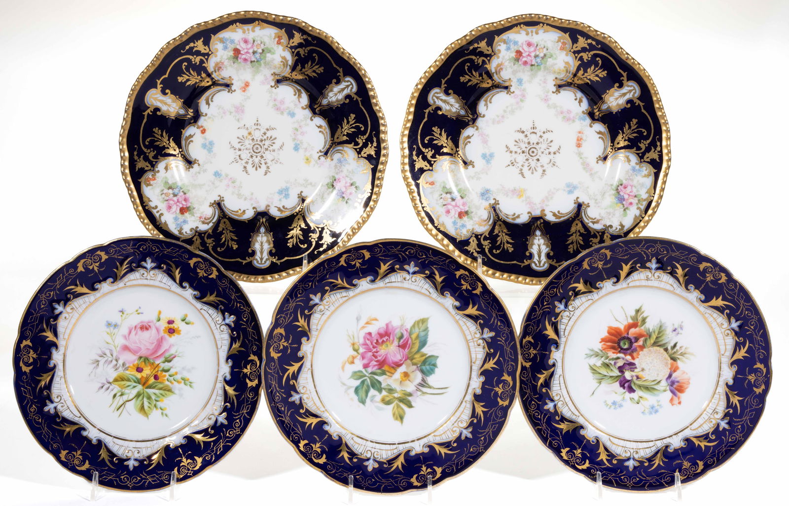 CONTINENTAL FLORAL MOTIF COBALT-DECORATED PORCELAIN PLATES, LOT OF FIVE: CONTINENTAL FLORAL MOTIF COBALT-DECORATED PORCELAIN PLATES, LOT OF FIVE, each having gilt scroll border designs, comprising three Fischer & Mieg hand-painted examples featuring bold, bea