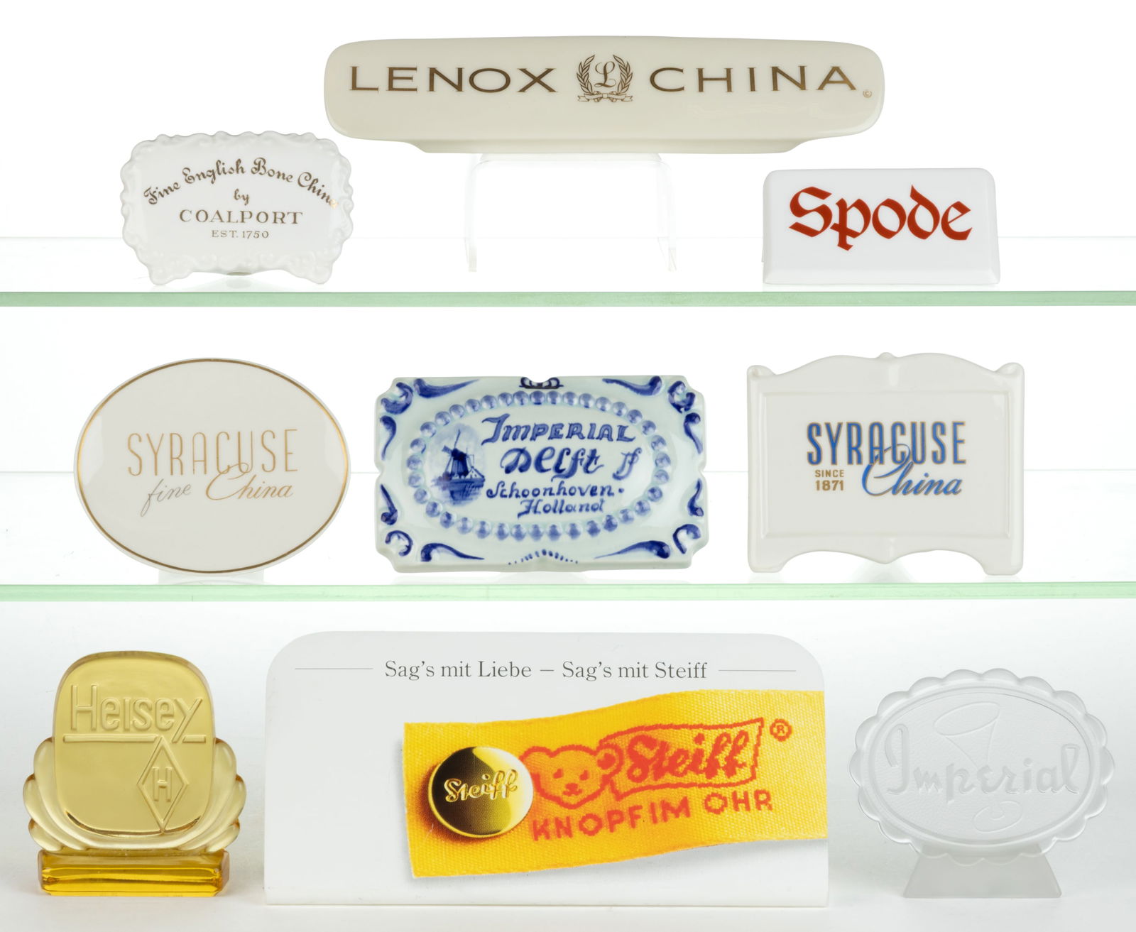 ASSORTED CERAMICS, GLASS, AND TOYS STORE SHELF SIGNS, LOT OF NINE: ASSORTED CERAMICS, GLASS, AND TOYS STORE SHELF SIGNS, LOT OF NINE, glass comprising a colorless Imperial and a topaz Heisey marked "HCA 86"; ceramics comprising Spode, Lenox, Coalport Bone C