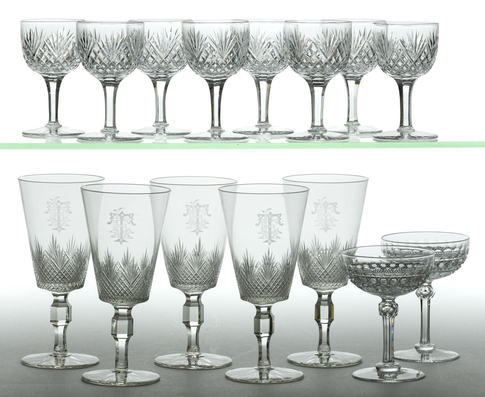 AMERICAN CUT GLASS DRINKING VESSELS, LOT OF 15: AMERICAN CUT GLASS DRINKING VESSELS, LOT OF 15, colorless, comprising a set of eight Diamond and Fan clarets, five Strawberry Diamond and Fan water goblets engraved with a three-letter monogram, and a