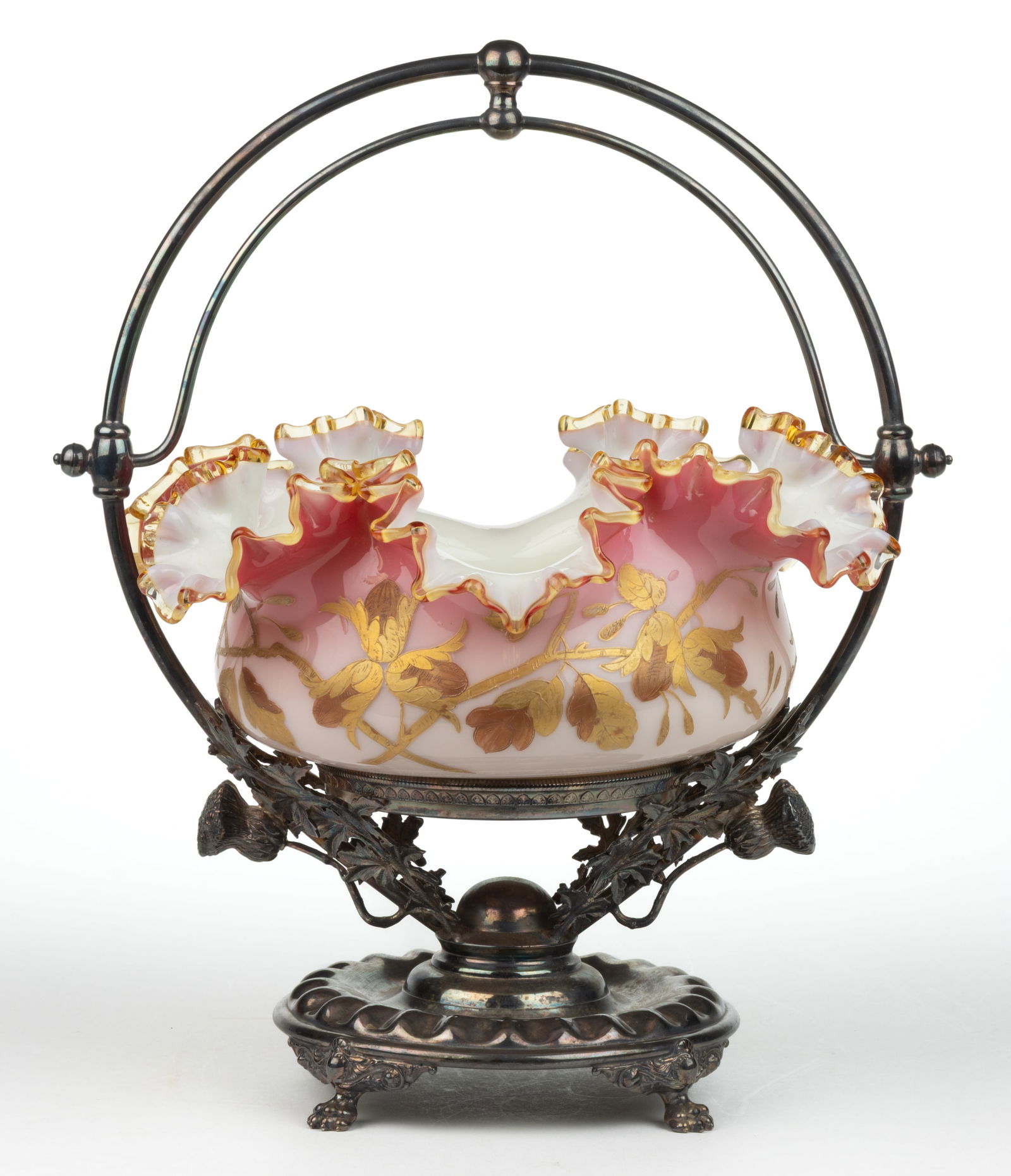 VICTORIAN CASED GLASS BRIDE'S BASKET: VICTORIAN CASED GLASS BRIDE'S BASKET, opaque white to peachblow with gilt-decoration, applied amber ruffled-rim, polished pontil mark, fitted into a quadruple-plate stand stamped fo