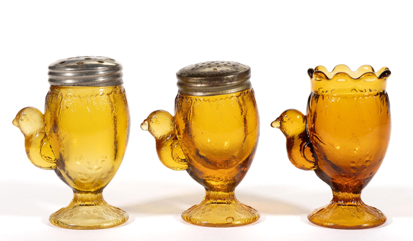 PRESSED FIGURAL EARLYBIRD GLASS CONDIMENT ARTICLES, LOT OF THREE: PRESSED FIGURAL EARLYBIRD GLASS CONDIMENT ARTICLES, LOT OF THREE, amber, comprising a salt and pepper shaker with period lids and a toothpick holder. Bellaire Goblet Co. Fourth quarter 19th centu