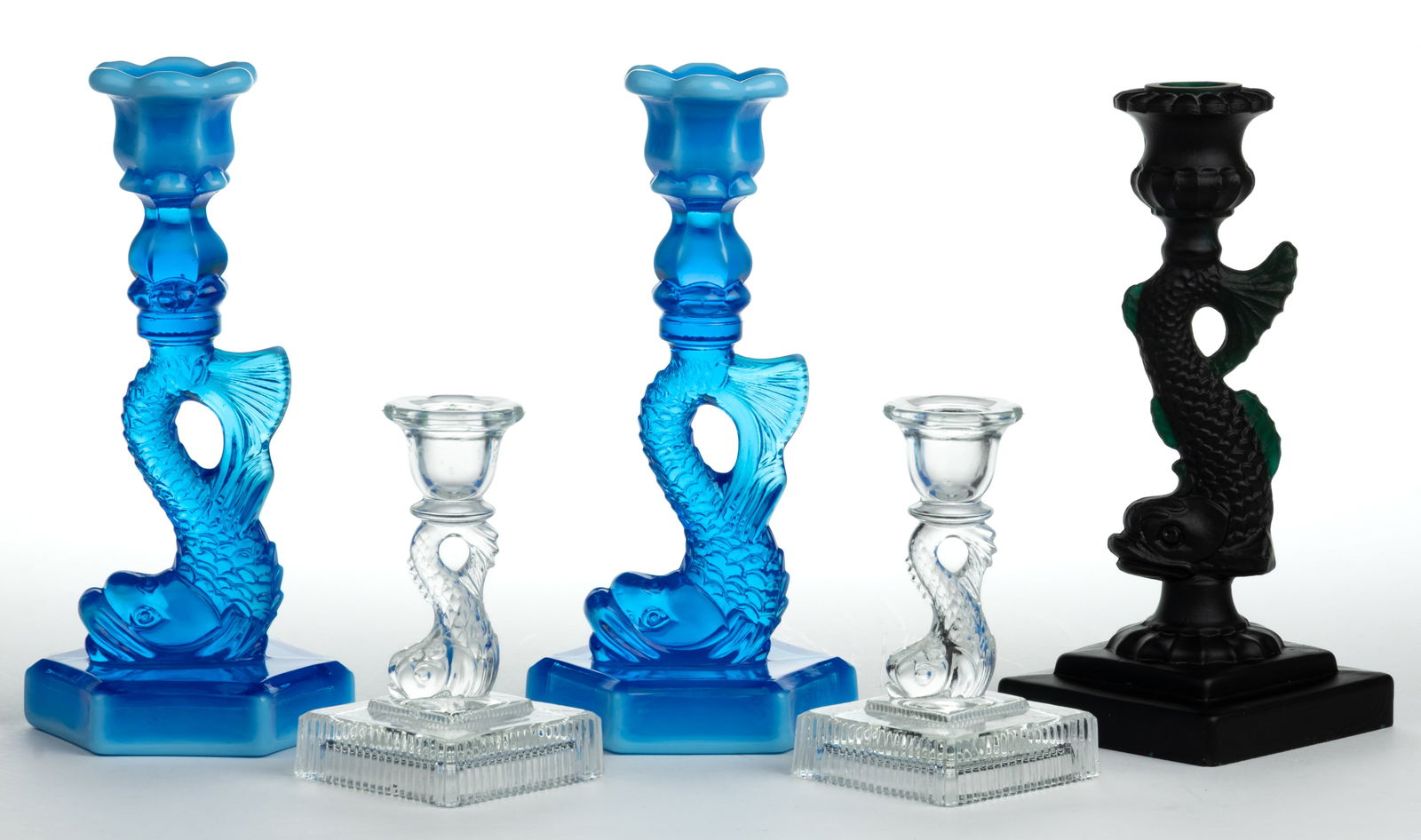 ASSORTED PRESSED DOLPHIN CANDLESTICKS, LOT OF FIVE: ASSORTED PRESSED DOLPHIN CANDLESTICKS, LOT OF FIVE, including a pair of blue opalescent six-petal sockets with lower extension raised on dolphin standard with a hexagonal base, single matte