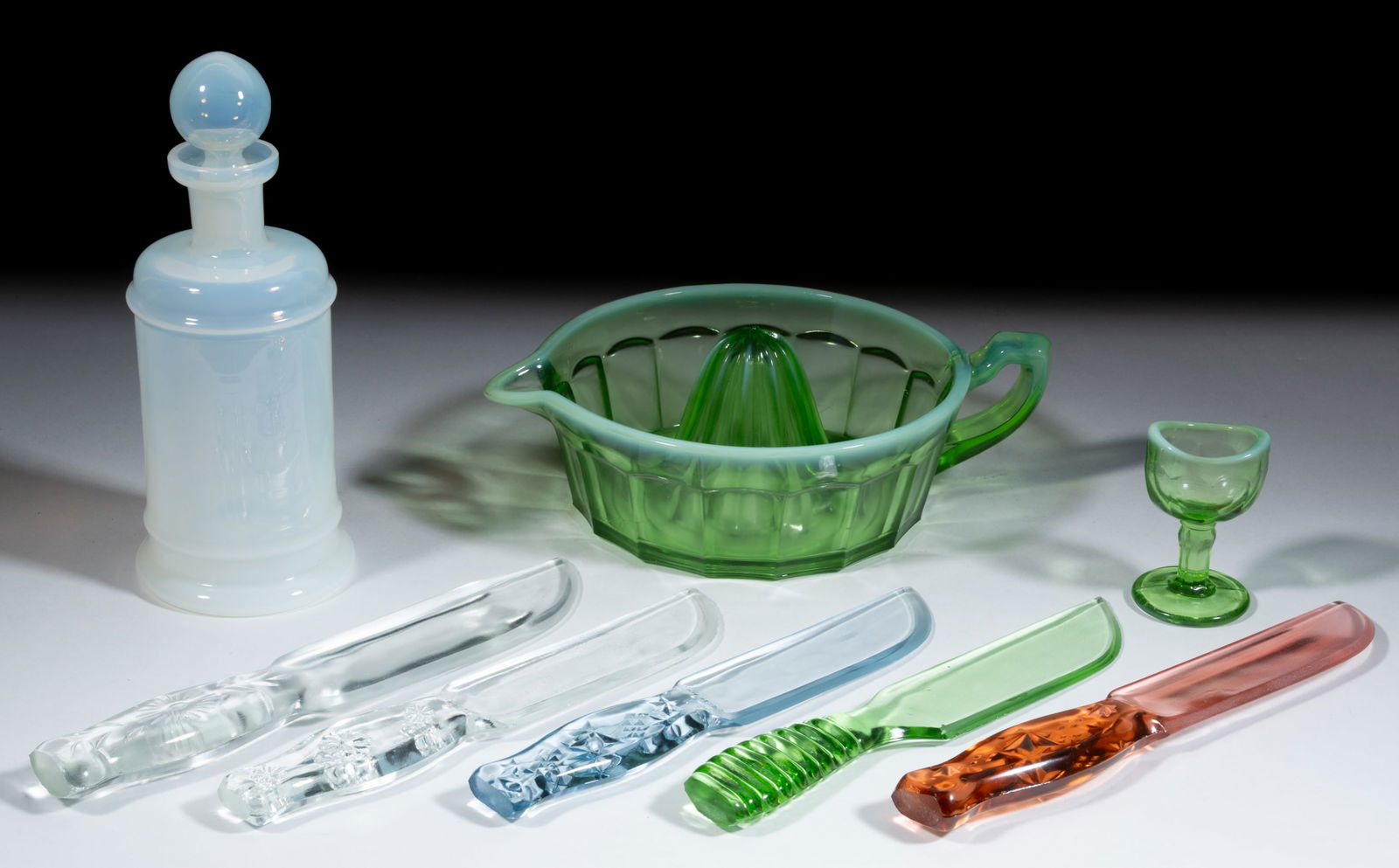 ASSORTED PRESSED GLASS NOVELTIES, LOT OF EIGHT: ASSORTED PRESSED GLASS NOVELTIES, LOT OF EIGHT, various colors, including green opalescent Summit Art Glass juicer, blue, pink, and colorless Vitex-Glas knives, colorless Cryst-O-Lite knife,