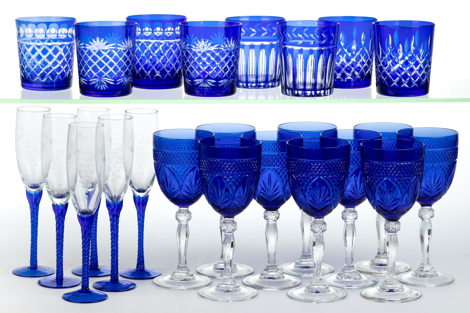 ASSORTED VINTAGE BLUE GLASS DRINKING VESSELS, LOT OF 24: ASSORTED VINTAGE BLUE GLASS DRINKING VESSELS, LOT OF 24, comprising a set of ten Cristal D'Arques-Durand "Antique Sapphire Blue" water goblets, a set of six engraved twist-stem