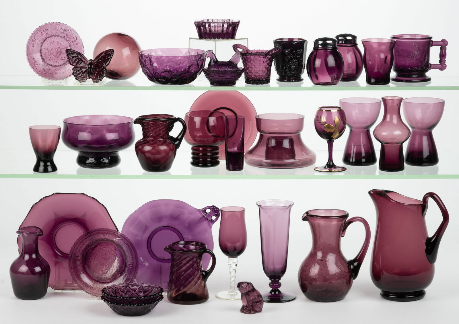 ASSORTED BLOWN AND PRESSED AMETHYST GLASS ARTICLES, LOT OF 35: ASSORTED BLOWN AND PRESSED AMETHYST GLASS ARTICLES, LOT OF 35, including a Blenko crackle glass miniature pitcher, Boyd butterfly, "Basket with Handles" toothpick holder, "Heart & A