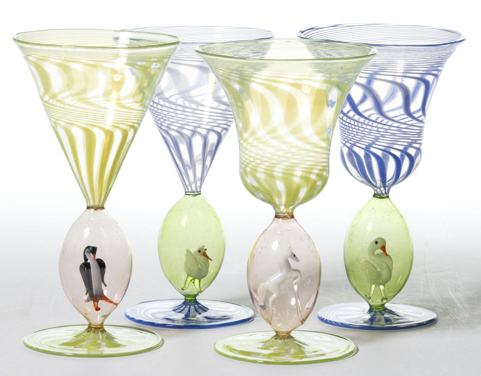 GERMAN ART GLASS BIMINI-TYPE CORDIAL / WINE GLASSES, SET OF FOUR: GERMAN ART GLASS BIMINI-TYPE CORDIAL / WINE GLASSES, SET OF FOUR, green and blue swirl over colorless, of two slightly different forms, each having a lampwork animal comprising two swan