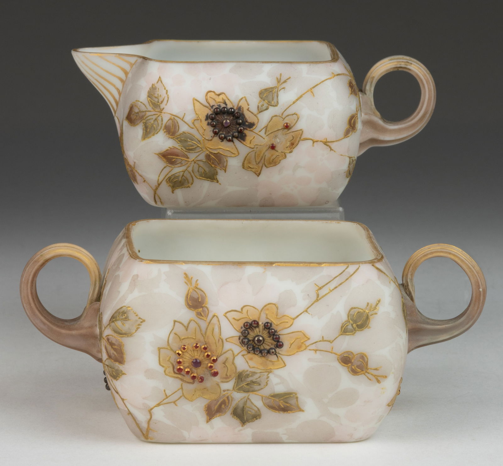 MOUNT WASHINGTON CROWN MILANO CREAMER AND SUGAR: MOUNT WASHINGTON CROWN MILANO CREAMER AND SUGAR, shape 531 with applied reeded handles, beige ground with gilt and polychrome-enamel Hawthorne decoration, applied red beads to the blossoms. Mount Wash