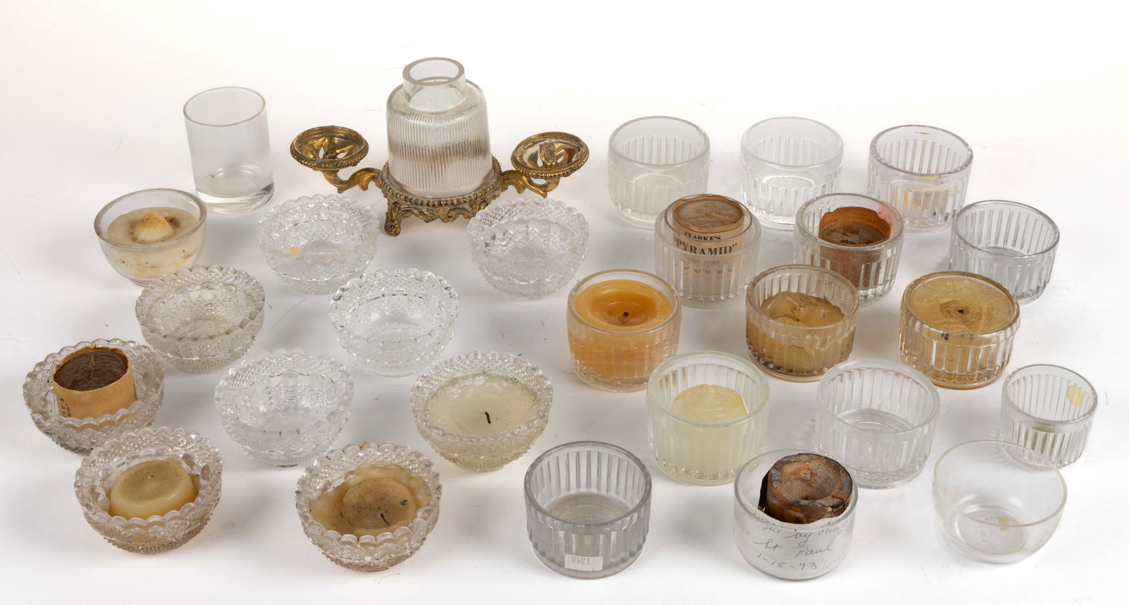 ASSORTED FAIRY LAMP ARTICLES, UNCOUNTED LOT: ASSORTED FAIRY LAMP ARTICLES, UNCOUNTED LOT, comprising 26 colorless candle votive cups including several with candles, various patterns and several embossed for S. Clarke; one brass finished cas