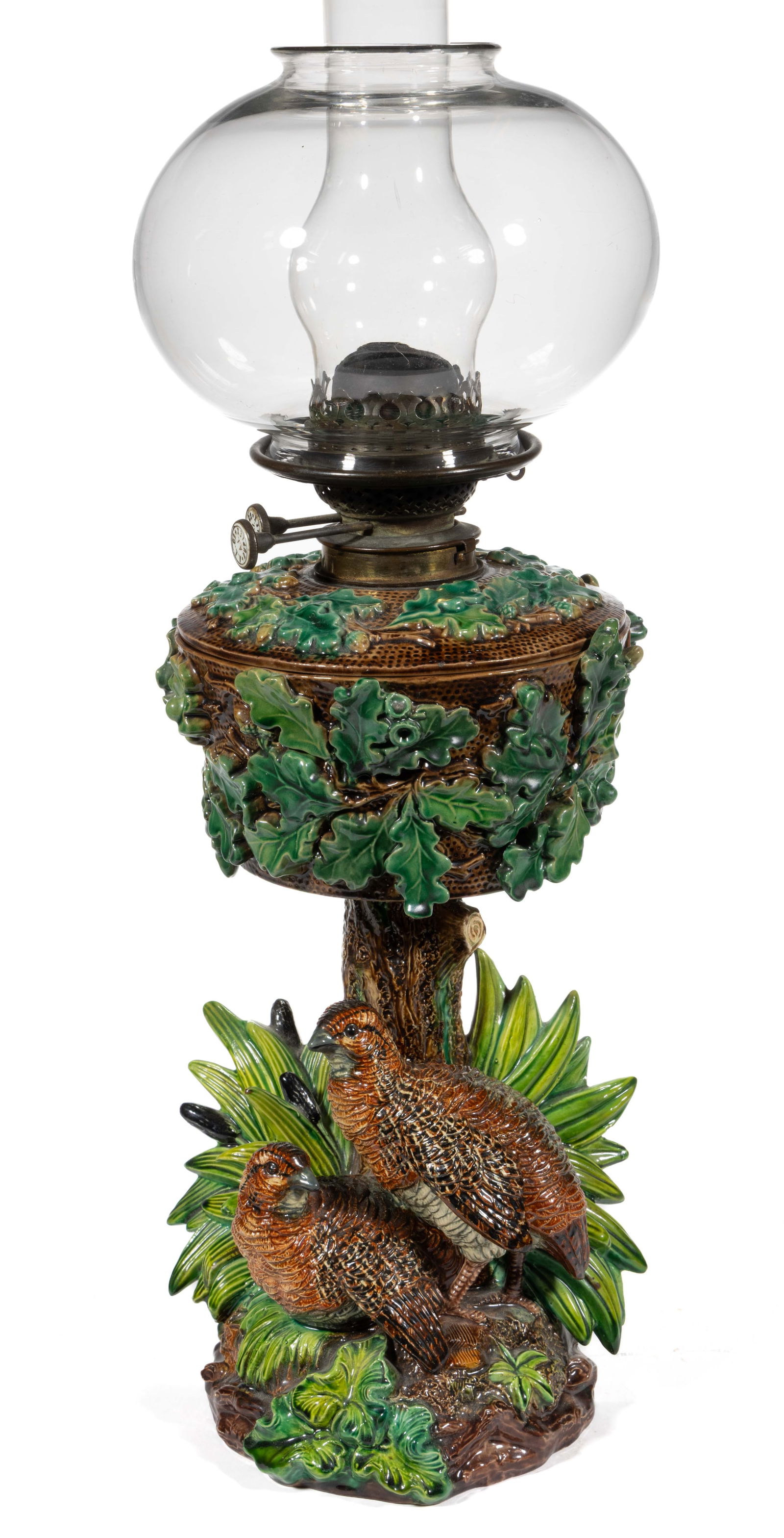 GERMAN HUGO LONITZ FIGURAL MAJOLICA KEROSENE VASE LAMP: GERMAN HUGO LONITZ FIGURAL MAJOLICA KEROSENE VASE LAMP, multi-color naturalistic decoration in greens and browns, figural base depicting two grouse standing beside a tree trunk and within a