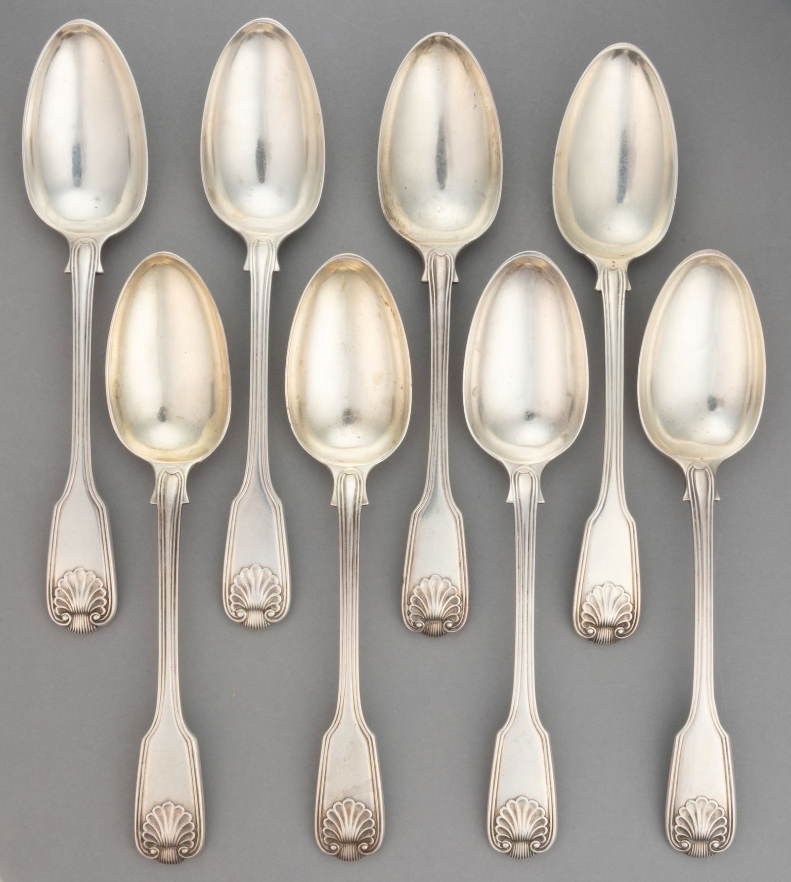 HAMILTON & CO., INDIAN COLONIAL SILVER TABLESPOONS, SET OF EIGHT: HAMILTON & CO., INDIAN COLONIAL SILVER TABLESPOONS, SET OF EIGHT, each piece with a fiddle thread and shell handle. Each impressed with "H&C" maker's mark for Hamilton & Co.