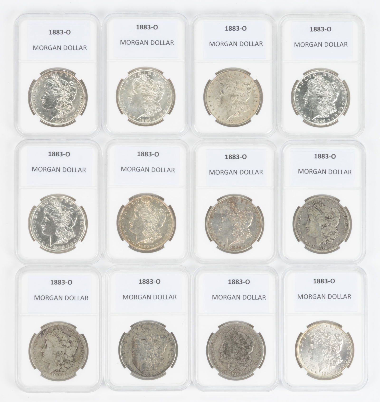 UNITED STATES 1883-O MORGAN SILVER DOLLAR COINS, LOT OF 12: UNITED STATES 1883-O MORGAN SILVER DOLLAR COINS, LOT OF 12, each housed in a plastic presentation case. Provenance: From the collection of a prominent Northern VA gentleman.