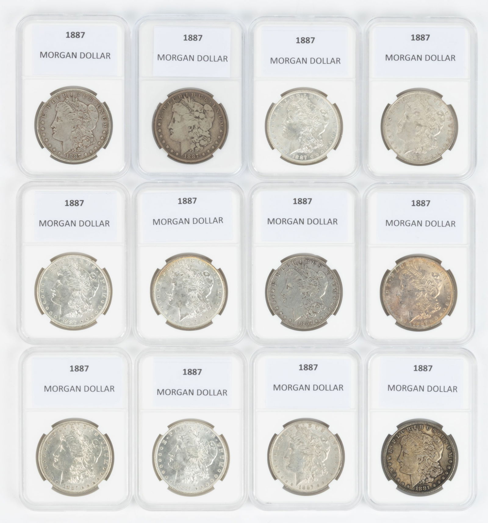 UNITED STATES 1887 MORGAN SILVER DOLLAR COINS, LOT OF 11: UNITED STATES 1887 MORGAN SILVER DOLLAR COINS, LOT OF 11, each housed in a plastic presentation case. Together with a 1881 Morgan Silver Dollar Coin housed in a plastic presentation case. Twelve piece