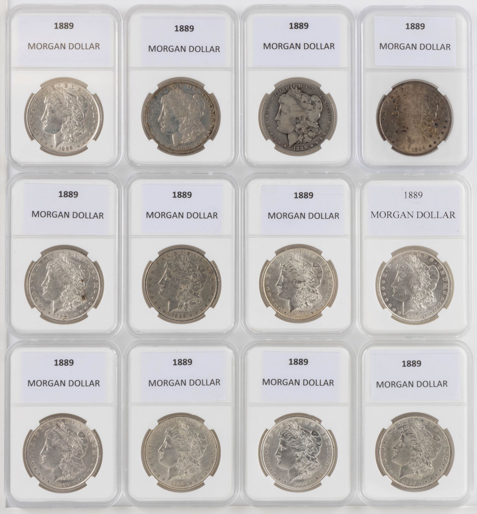 UNITED STATES 1889 MORGAN SILVER DOLLAR COINS, LOT OF 12: UNITED STATES 1889 MORGAN SILVER DOLLAR COINS, LOT OF 12, each housed in a plastic presentation case. Provenance: From the collection of a prominent Northern VA gentleman.