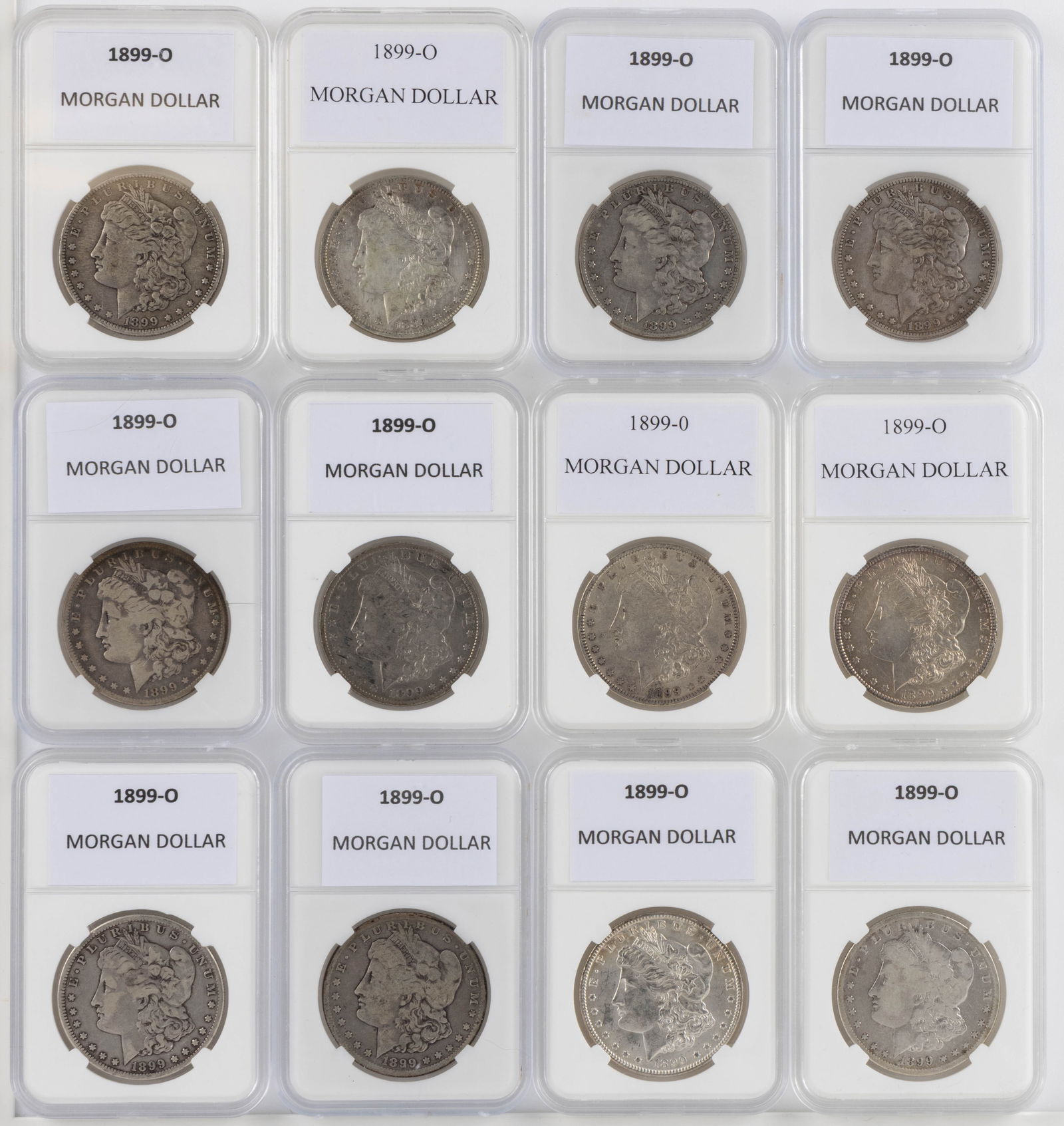 UNITED STATES 1899-O MORGAN SILVER DOLLAR COINS, LOT OF 11: UNITED STATES 1899-O MORGAN SILVER DOLLAR COINS, LOT OF 11, each housed in a plastic presentation case. Together with a 1889-O Morgan Silver Dollar Coin housed in a plastic presentation case. Twelve p