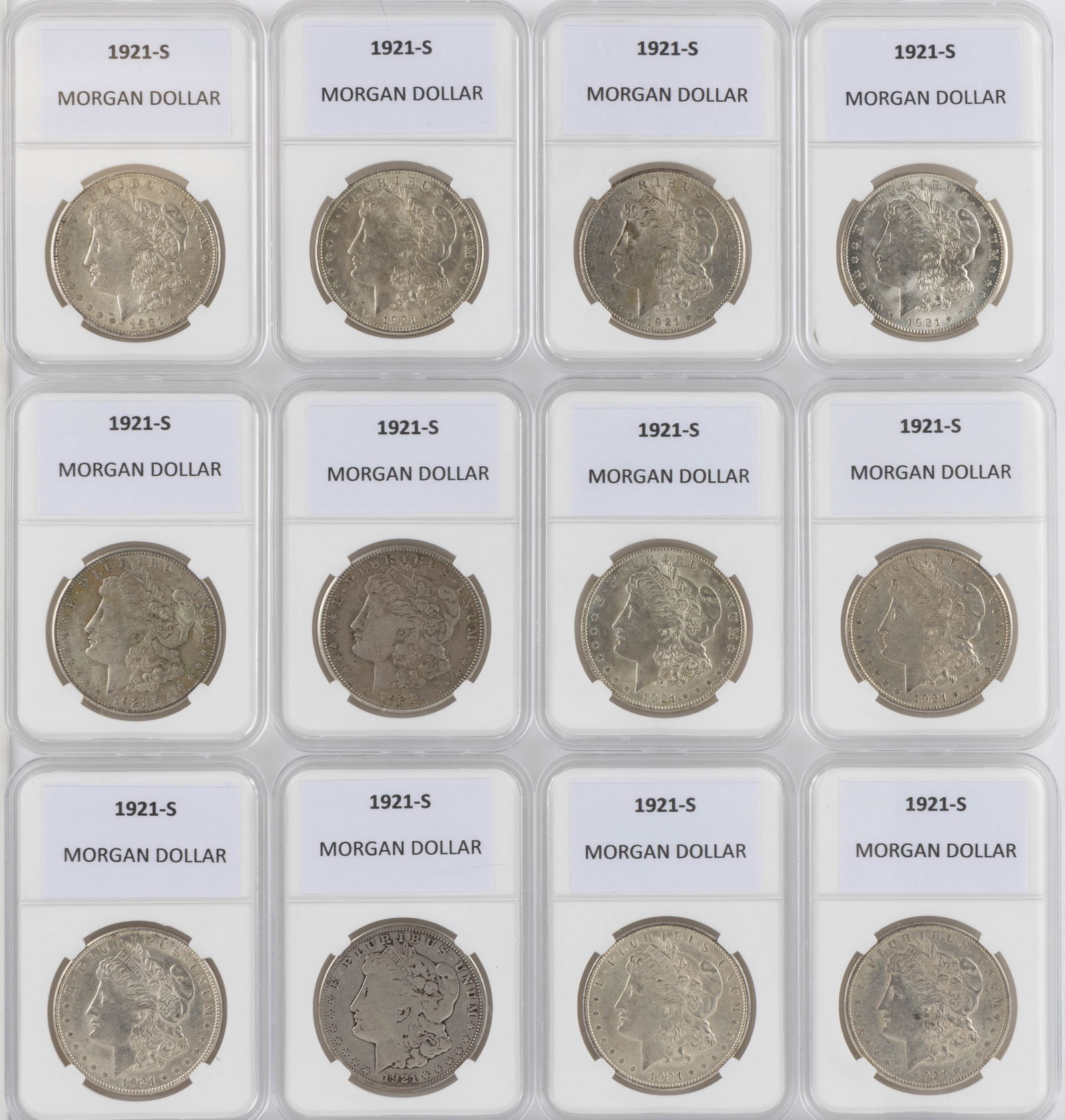 UNITED STATES 1921-S MORGAN SILVER DOLLAR COINS, LOT OF 12: UNITED STATES 1921-S MORGAN SILVER DOLLAR COINS, LOT OF 12, each housed in a plastic presentation case. Provenance: From the collection of a prominent Northern VA gentleman.