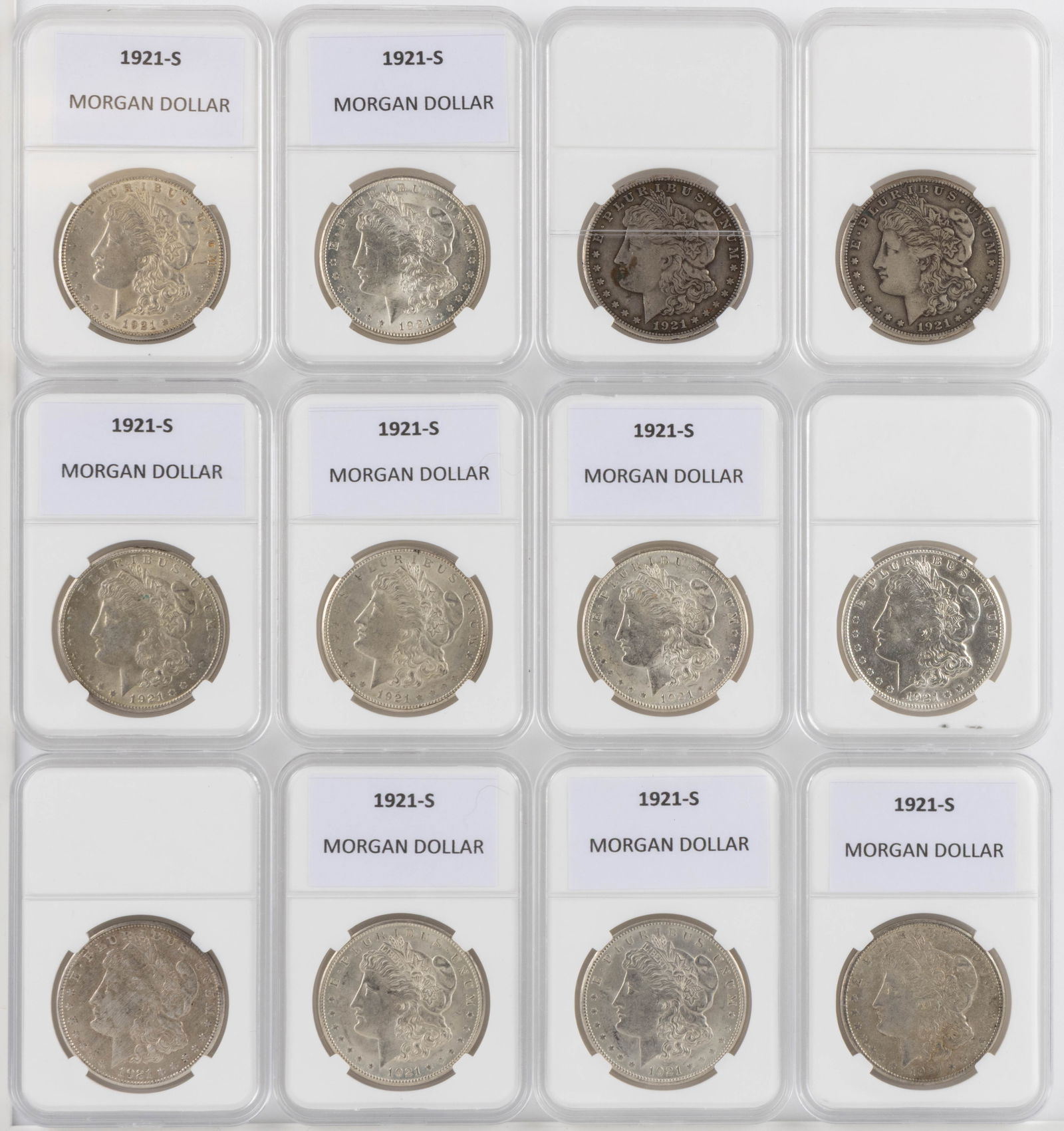 UNITED STATES 1921-S MORGAN SILVER DOLLAR COINS, LOT OF 12: UNITED STATES 1921-S MORGAN SILVER DOLLAR COINS, LOT OF 12, each housed in a plastic presentation case. Provenance: From the collection of a prominent Northern VA gentleman.