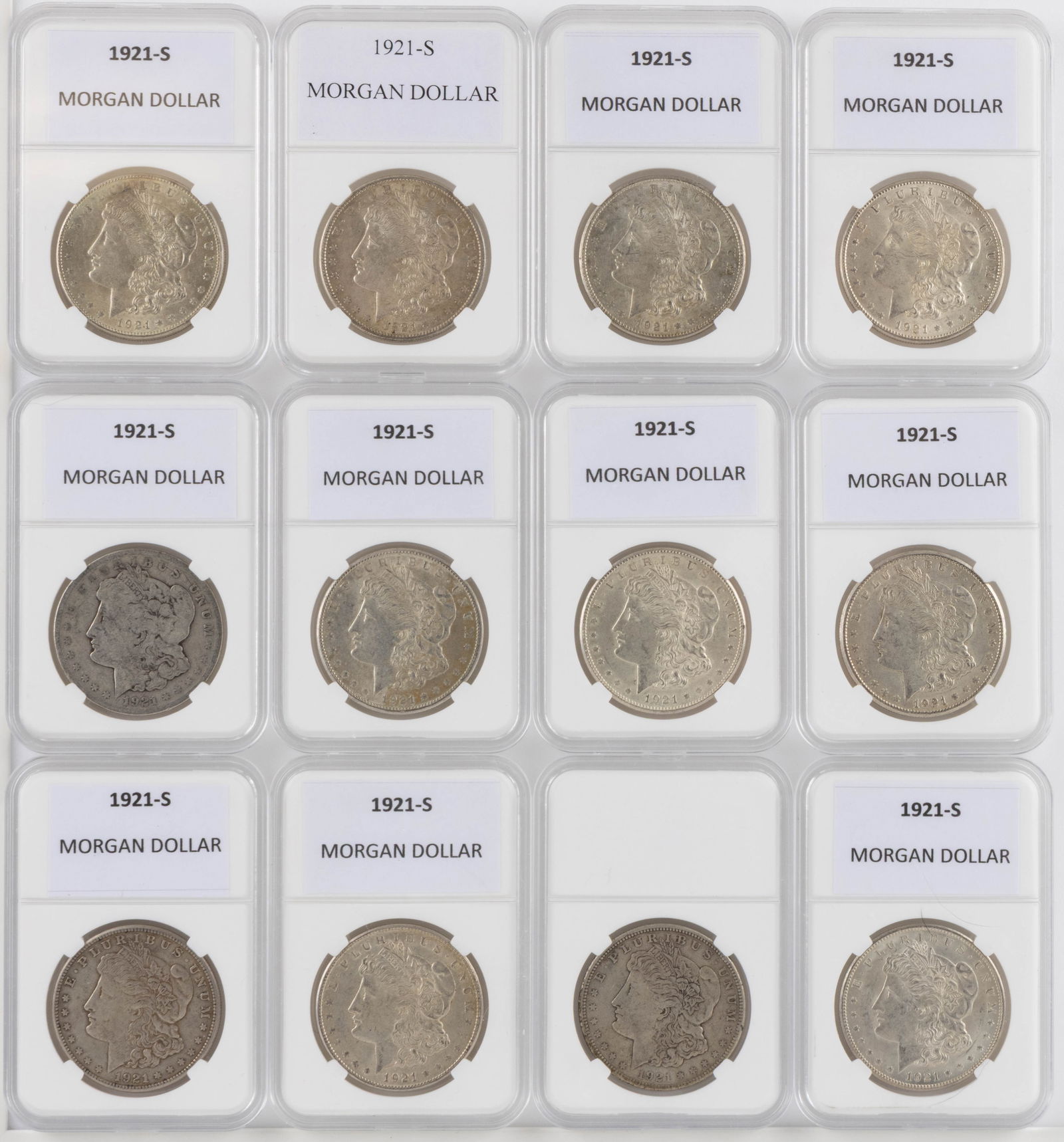 UNITED STATES 1921-S MORGAN SILVER DOLLAR COINS, LOT OF 12: UNITED STATES 1921-S MORGAN SILVER DOLLAR COINS, LOT OF 12, each housed in a plastic presentation case. Provenance: From the collection of a prominent Northern VA gentleman.