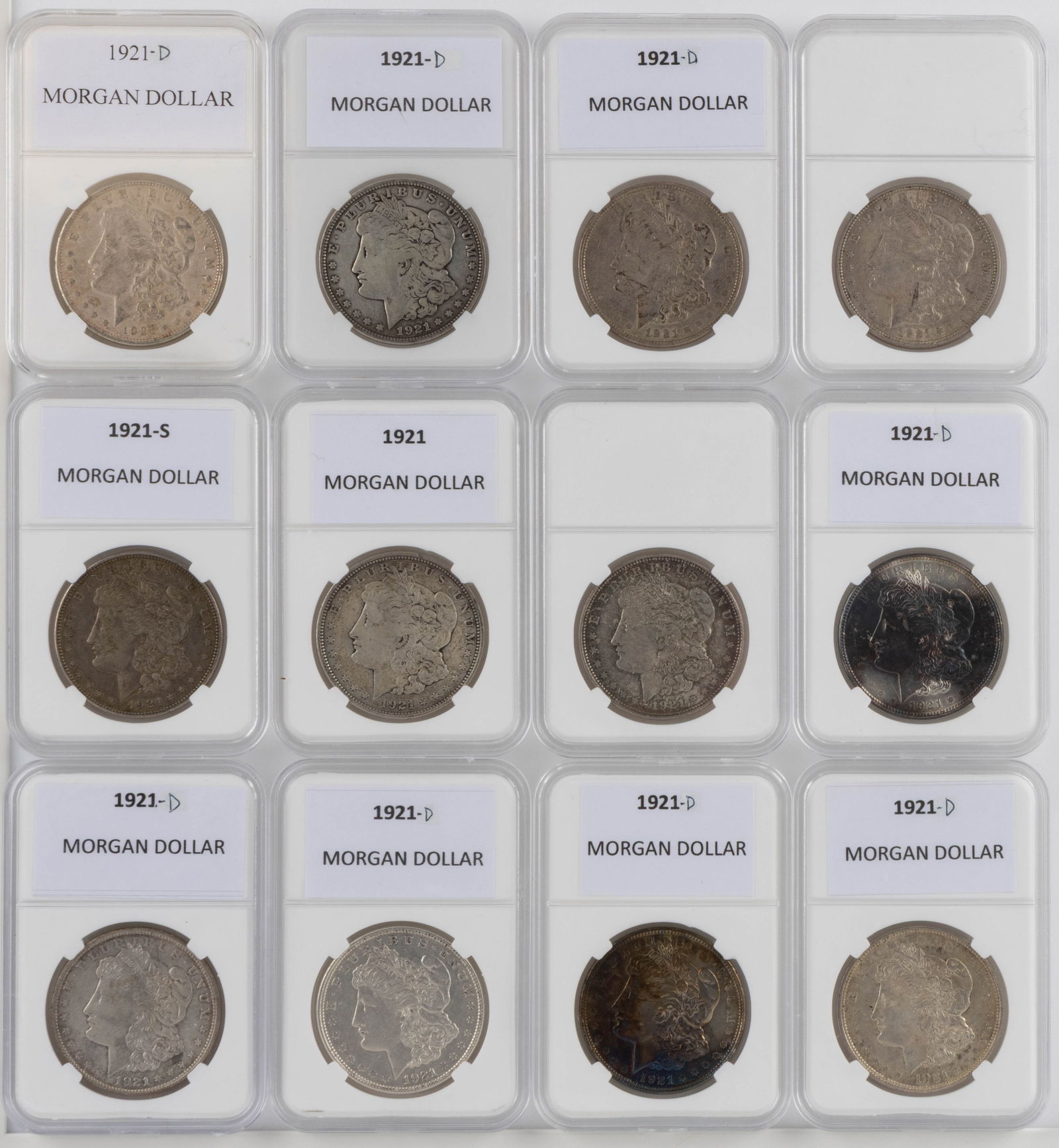 UNITED STATES 1921-D MORGAN SILVER DOLLAR COINS, LOT OF 12: UNITED STATES 1921-D MORGAN SILVER DOLLAR COINS, LOT OF 12, each housed in a plastic presentation case. Provenance: From the collection of a prominent Northern VA gentleman.