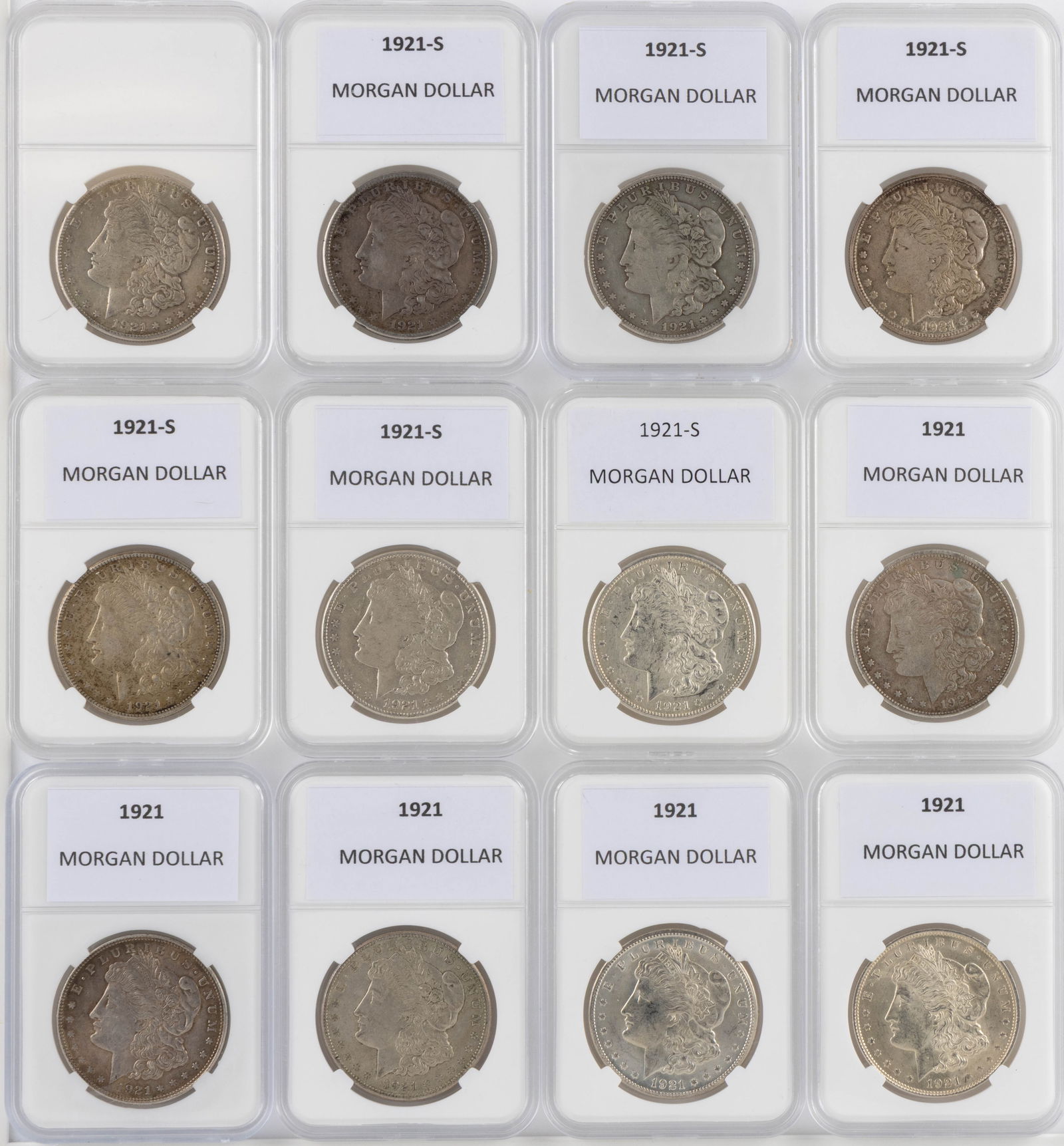 ASSORTED UNITED STATES 1921 MORGAN SILVER DOLLAR COINS, LOT OF 12: ASSORTED UNITED STATES 1921 MORGAN SILVER DOLLAR COINS, LOT OF 12, comprising five 1921 and seven 1921-S, each housed in a plastic presentation case. Provenance: From the collection of a prominent No