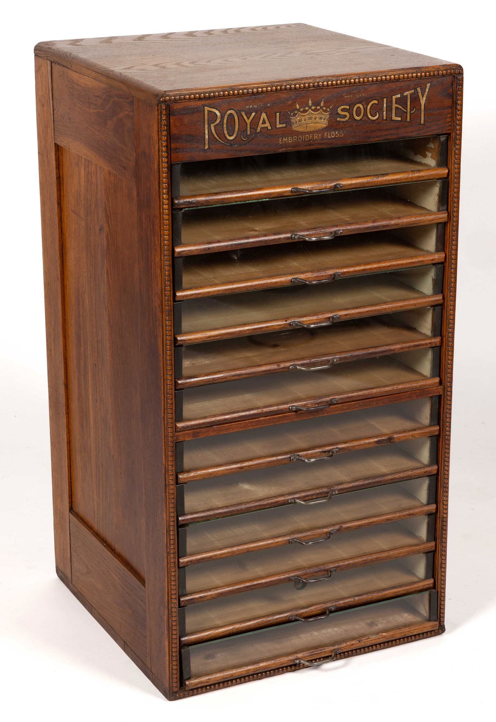 ROYAL SOCIETY EMBROIDERY FLOSS OAK COUNTRY STORE FLOOR THREAD CABINET: ROYAL SOCIETY EMBROIDERY FLOSS OAK COUNTRY STORE FLOOR THREAD CABINET, old surface, one piece construction, top with gold stenciling "Royal Society Embroidery Floss" over 12 pull-o