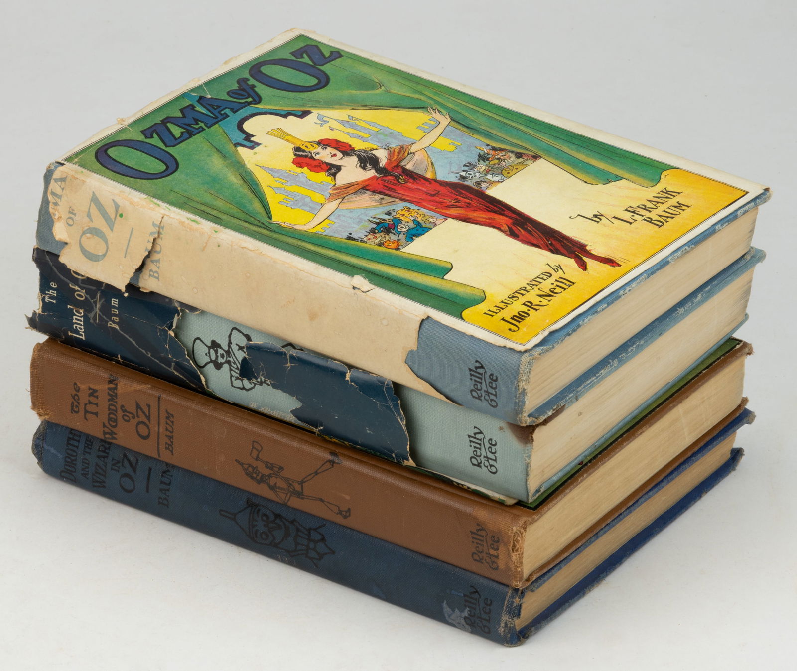 L. FRANK BAUM OZ VOLUMES, LOT OF FOUR: L. FRANK BAUM OZ VOLUMES, LOT OF FOUR, comprising (1) Ozma of Oz, 1907; (2) Dorothy and the Wizard in Oz, 1908; (3) The Tin Woodman of Oz, 1918; and (4) The Land of