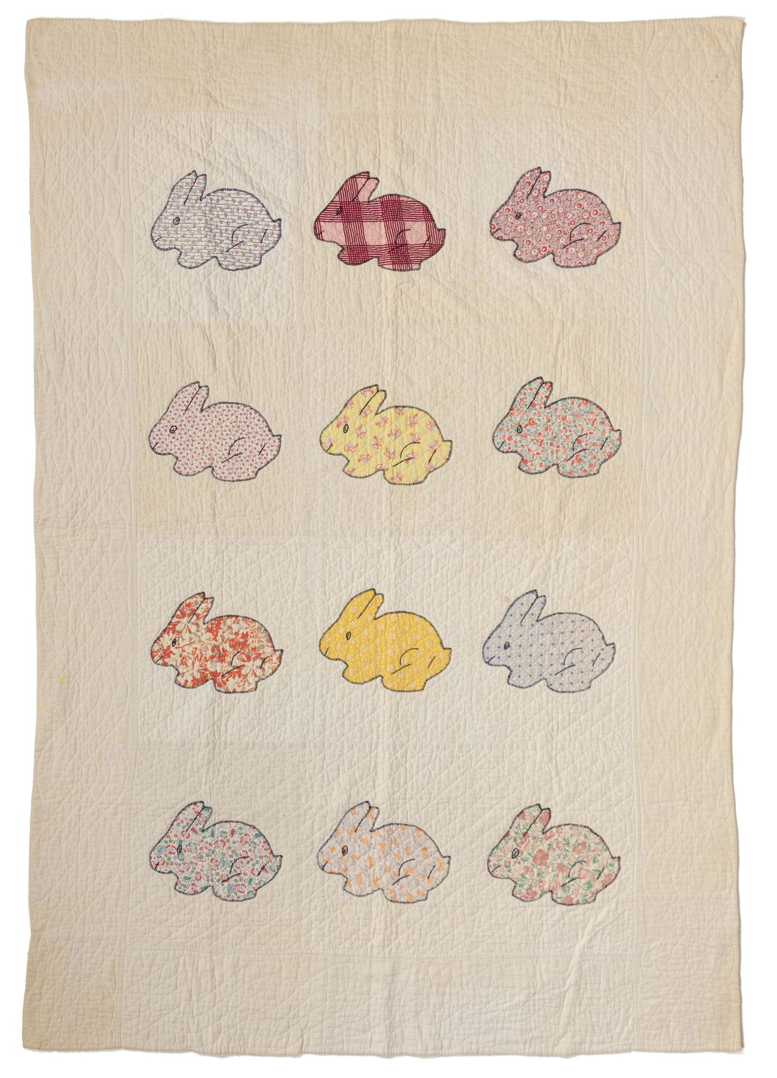 AMERICAN "BUNNY" APPLIQUE YOUTH QUILT: AMERICAN "BUNNY" APPLIQUE YOUTH QUILT, hand-stitched with machine-stitched seams, 12 pattern blocks of same bunny figural motif in polychrome print fabrics with black embroidery thread outli
