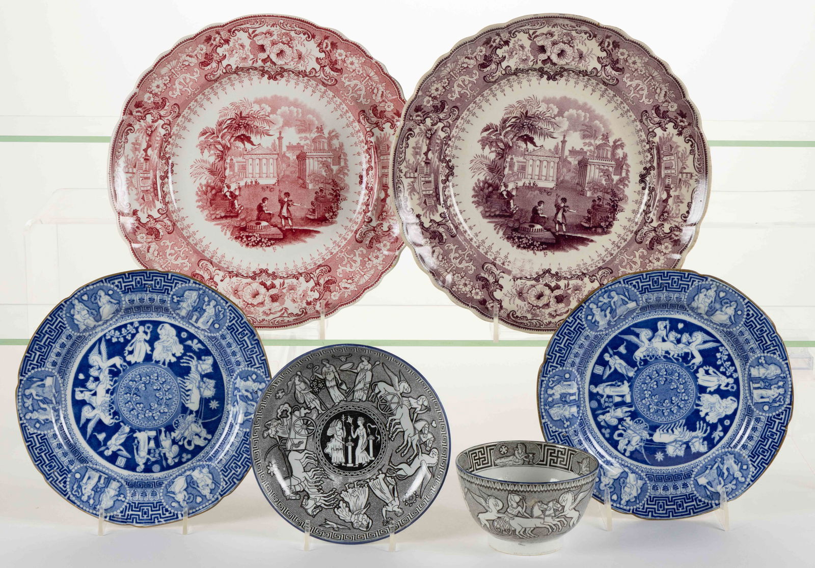 STAFFORDSHIRE TRANSFER-PRINTED CERAMIC GREEK MOTIF ARTICLES, LOT OF FIVE: STAFFORDSHIRE TRANSFER-PRINTED CERAMIC GREEK MOTIF ARTICLES, LOT OF FIVE, comprising a cup and saucer set featuring Attack of the Griffins depicting classical figures and chariots and four plates