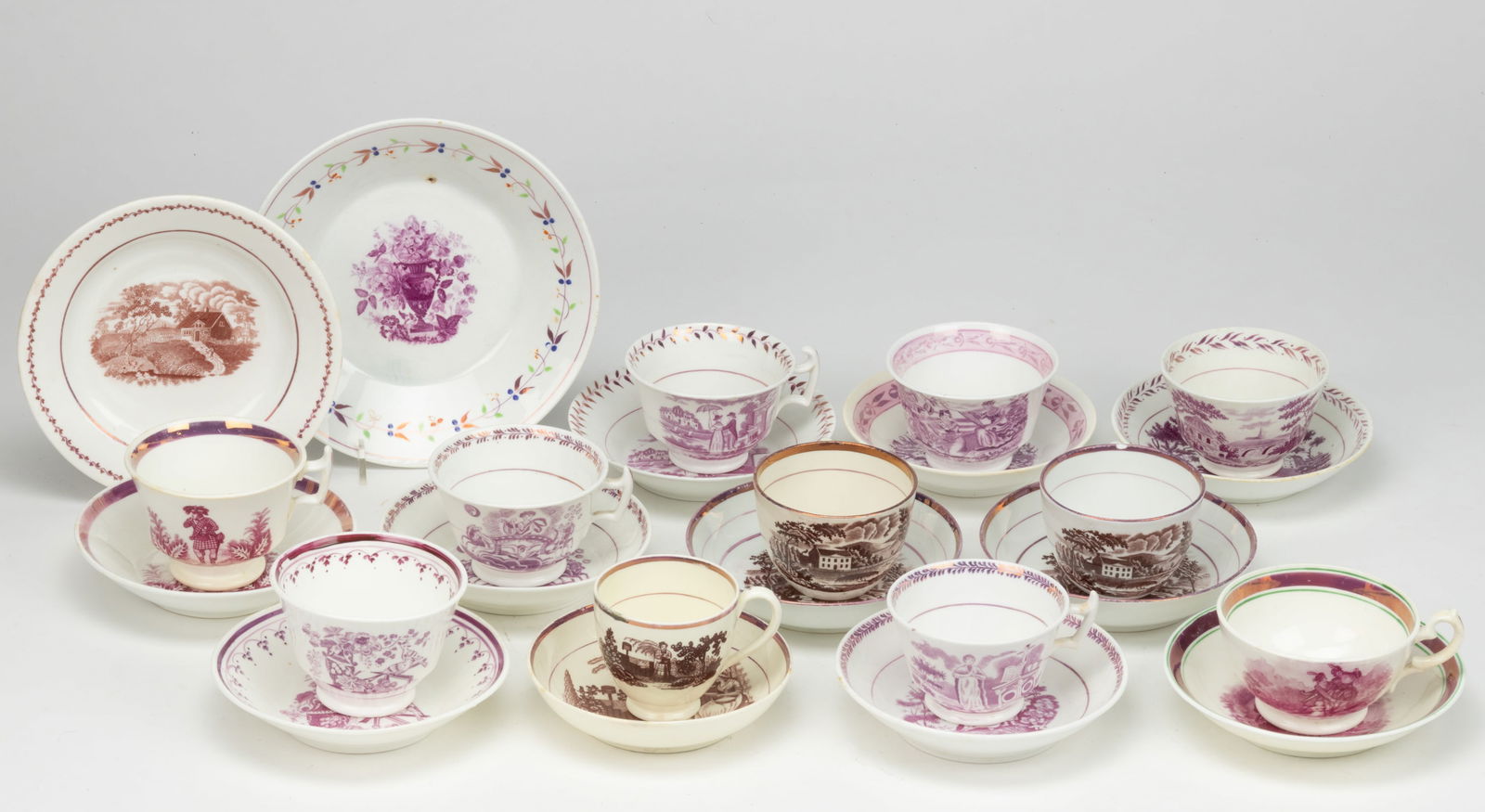 STAFFORDSHIRE BAT- / TRANSFER-PRINTED CERAMIC CUP AND SAUCER SETS, LOT OF 11: STAFFORDSHIRE BAT- / TRANSFER-PRINTED CERAMIC CUP AND SAUCER SETS, LOT OF 11, most having pink lustre rim decorations, including eight examples having mulberry transfers including one featuring female