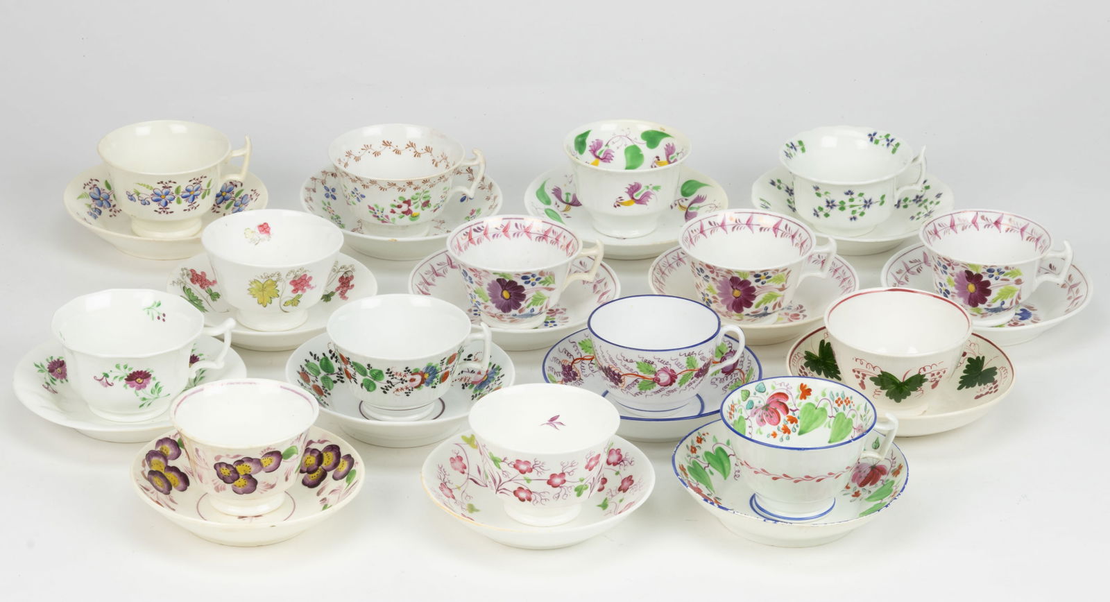 BRITISH HAND-PAINTED CERAMIC FLORAL MOTIF CUP AND SAUCER SETS, LOT OF 15: BRITISH HAND-PAINTED CERAMIC FLORAL MOTIF CUP AND SAUCER SETS, LOT OF 15, each having polychrome decorations, including one set featuring strawberry and flowers design, one set having blue cornfl