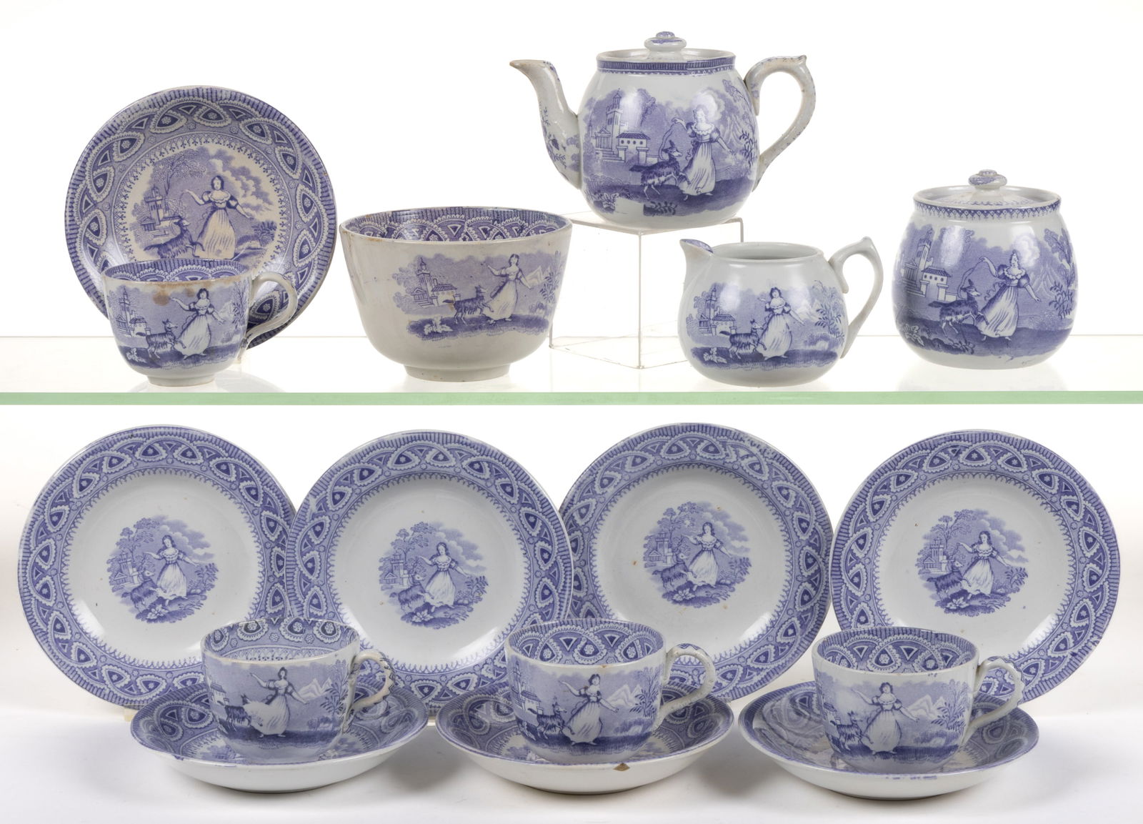 STAFFORDSHIRE TRANSFER-PRINTED CERAMIC "GOAT" CHILDREN'S 12-PIECE TOY TEA SET: STAFFORDSHIRE TRANSFER-PRINTED CERAMIC "GOAT" CHILDREN'S 12-PIECE TOY TEA SET, each having blue transfer scene depicting a young lady and a leaping goat at her side, comprising a te