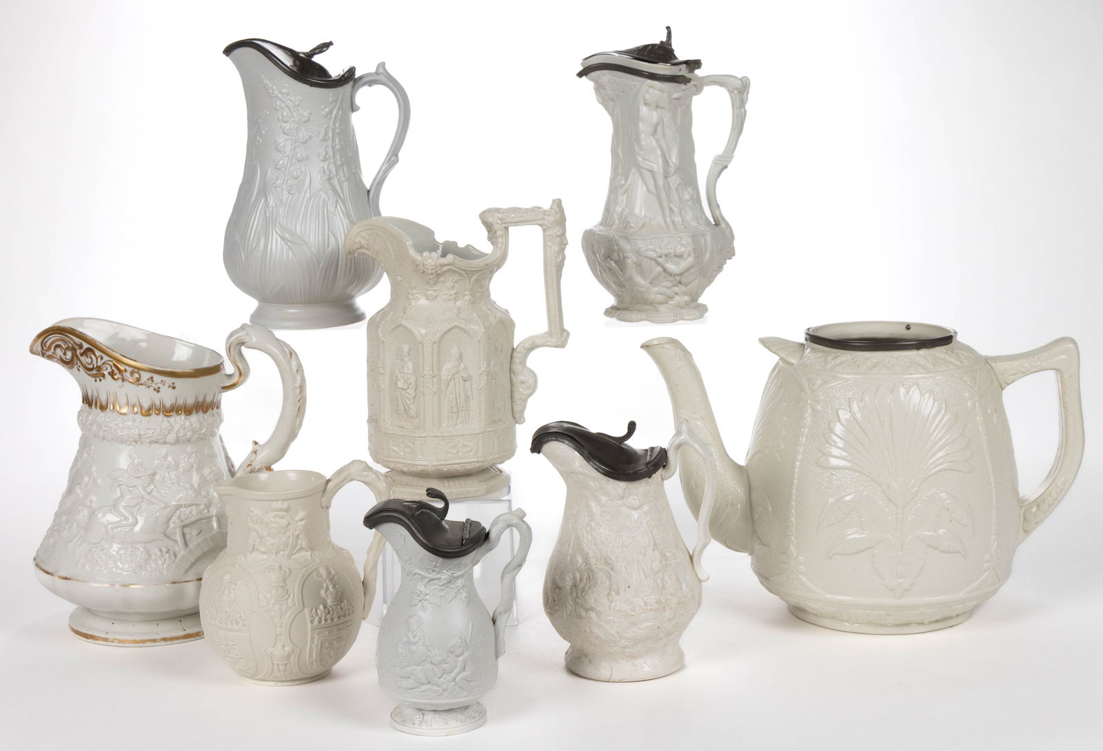 ENGLISH RELIEF-MOLDED STONEWARE JUGS AND OTHER RELATED ARTICLES, LOT OF EIGHT (1 of 2)