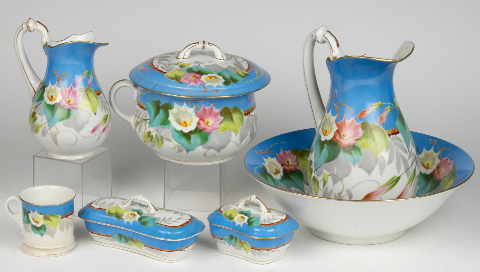 FRENCH DECORATED CERAMIC SEVEN-PIECE CHAMBER SET: FRENCH DECORATED CERAMIC SEVEN-PIECE CHAMBER SET, each featuring polychrome hand-painted morning glory pattern, comprising a covered chamber pot with handle, a covered soap dish with insert,