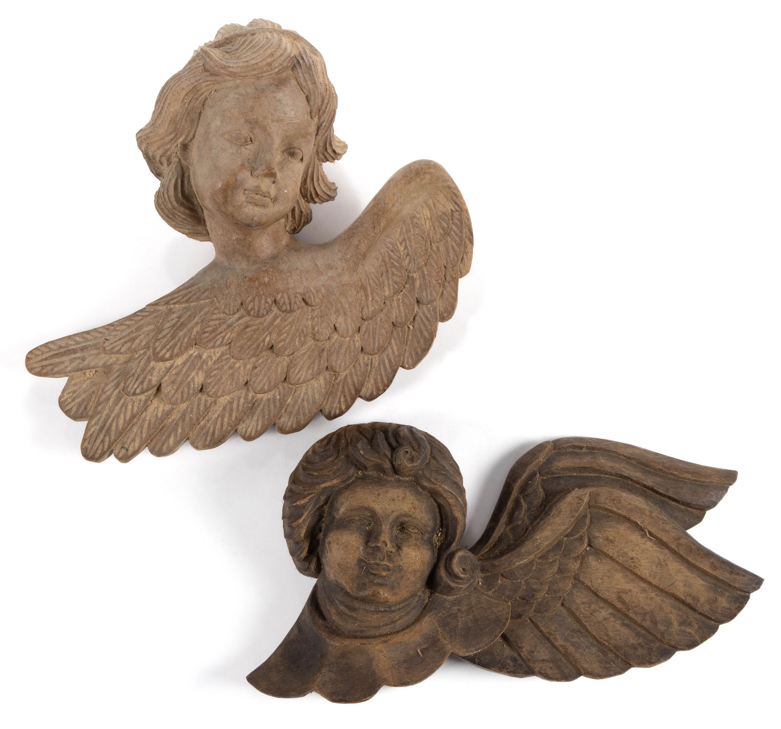 FOLK ART CARVED WOODEN TAKAAN ANGEL PAPIER-MACHE MOLDS, LOT OF TWO: FOLK ART CARVED WOODEN TAKAAN ANGEL PAPIER-MACHE MOLDS, LOT OF TWO, each of solid form, depicting stylized angels or cherubs with a wing below their neck. Each retains the original waxed working surfa