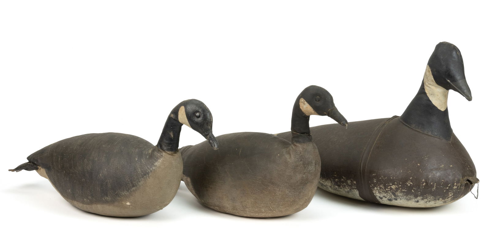 PAINTED CANVAS CANADIAN GOOSE DECOYS, LOT OF THREE: PAINTED CANVAS CANADIAN GOOSE DECOYS, LOT OF THREE, each constructed from canvas over a buoyant substrate, two with tack eyes, each retain early or original painted surface. First half