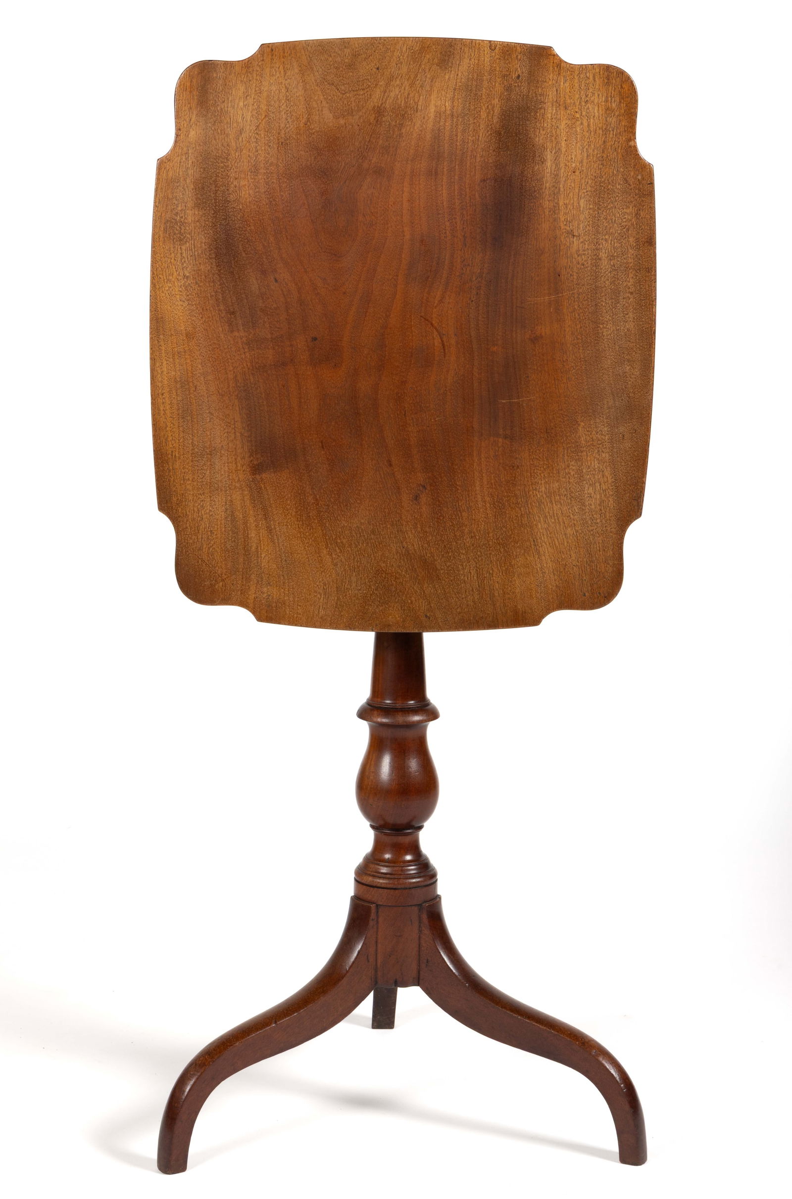 AMERICAN LATE FEDERAL MAHOGANY TILT-TOP CANDLESTAND: AMERICAN LATE FEDERAL MAHOGANY TILT-TOP CANDLESTAND, the single-board shaped rectangular top with a battens applied to the underside over a turned standard, the whole raised on simple