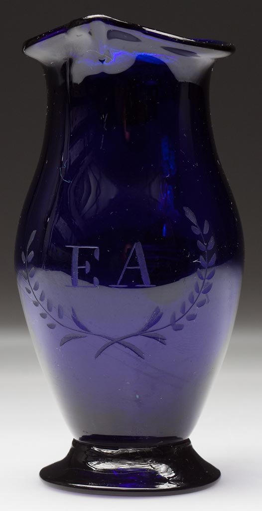 FREE-BLOWN AND ENGRAVED STIEGEL-TYPE CREAM JUG / PITCHE: FREE-BLOWN AND ENGRAVED STIEGEL-TYPE CREAM JUG / PITCHER, deep cobalt blue, tall ovoid body with pulled spout and solid applied handle, engraved "EA" within a wreath below the spout, raised on an appl