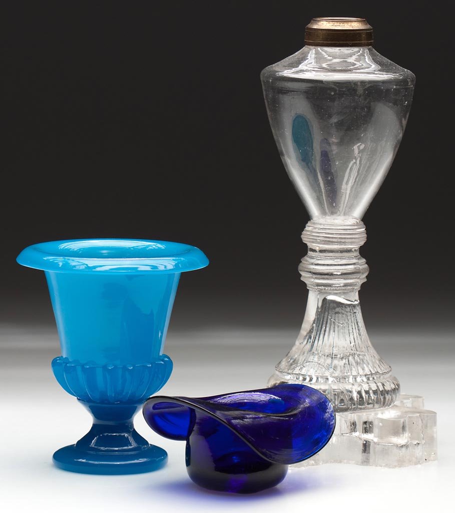 ASSORTED BLOWN ARTICLES, LOT OF THREE: ASSORTED BLOWN ARTICLES, LOT OF THREE, comprising a cobalt blue hat whimsy with rough pontil mark, a blue opaline urn with gadrooning and a polished pontil mark, and a blown and pressed whale oil lamp