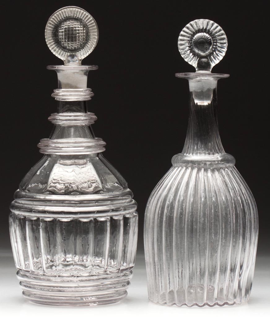 BLOWN-MOLDED QUART DECANTERS, LOT OF TWO: BLOWN-MOLDED QUART DECANTERS, LOT OF TWO, colorless, comprising a GI-7, Type III and a GI-29 with three applied annular neck rings, each with rough pontil mark and appropriate pressed stopper. Boston 