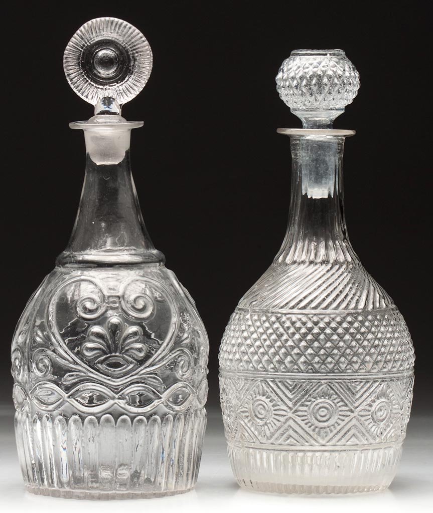 BLOWN-MOLDED QUART DECANTERS, LOT OF TWO: BLOWN-MOLDED QUART DECANTERS, LOT OF TWO, colorless, comprising a GIII-24 with rayed base and a GV-13 with plain base, each with rough pontil mark and appropriate stopper. Boston & Sandwich Glass Co. 