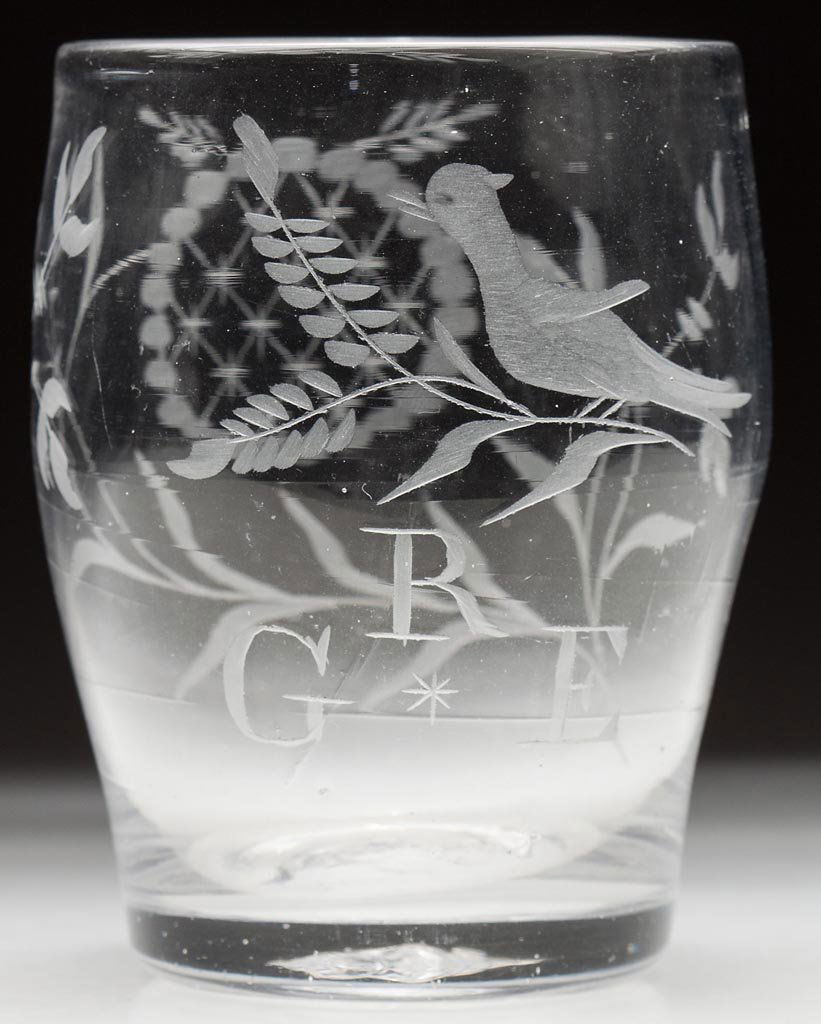 FREE-BLOWN AND ENGRAVED STIEGEL-TYPE TUMBLER: FREE-BLOWN AND ENGRAVED STIEGEL-TYPE TUMBLER, colorless, barrel form engraved with a bird on branch above "R / G * E" backed with floral decoration, rough pontil mark. Late 18th/early 19th century. 3