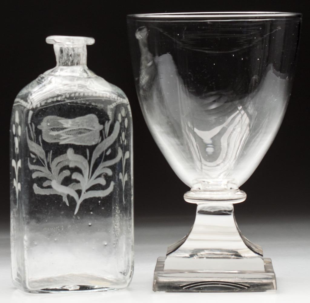 FREE-BLOWN DRINKING ARTICLES, LOT OF TWO: FREE-BLOWN DRINKING ARTICLES, LOT OF TWO, colorless, comprising an undecorated rummer with polished square base and a half-post engraved cordial bottle with rough pontil mark. 19th century. 6" and 6 3