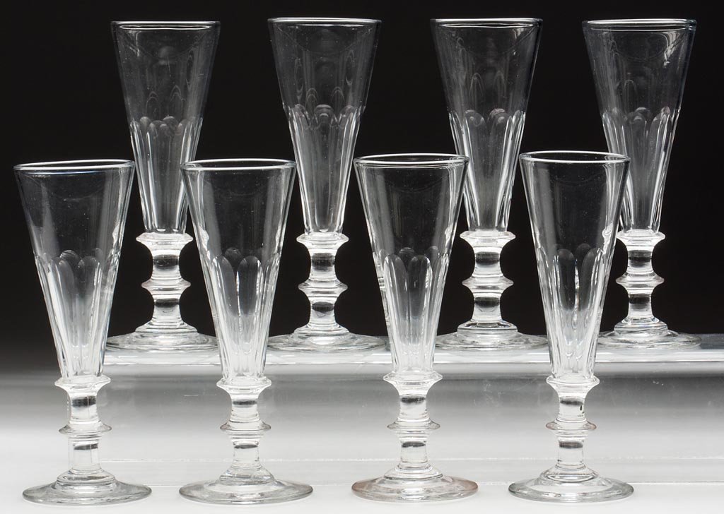 FREE-BLOWN AND CUT FLUTES, SET OF EIGHT: FREE-BLOWN AND CUT FLUTES, SET OF EIGHT, colorless lead glass, each deep conical bowl cut with eight flutes, raised on a bladed-knop stem and circular foot with polished pontil mark. Pittsburgh and ot