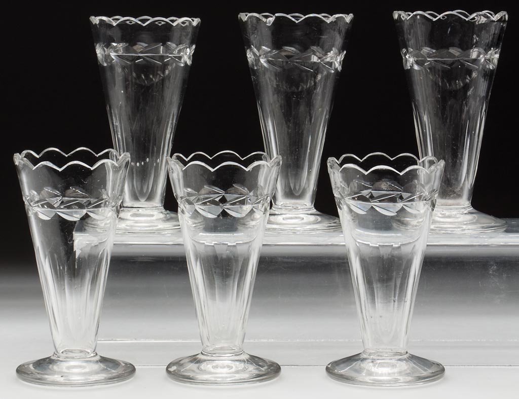 SET OF SIX BLOWN AND CUT SYLLABUB / JELLY GLASSES: SET OF SIX BLOWN AND CUT SYLLABUB / JELLY GLASSES, colorless lead glass, each with a leaf band above flutes, polished pontil marks. 19th century. 4 1/2" H. Provenance: The estate collection of Richard