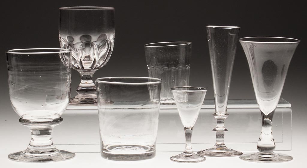 ASSORTED BLOWN DRINKING VESSELS, LOT OF SEVEN: ASSORTED BLOWN DRINKING VESSELS, LOT OF SEVEN, colorless, including a pattern-molded goblet and small tumbler, wine with folded foot, rough and polished pontil mark. 19th century. 3 5/8" to 7 1/2" H. 