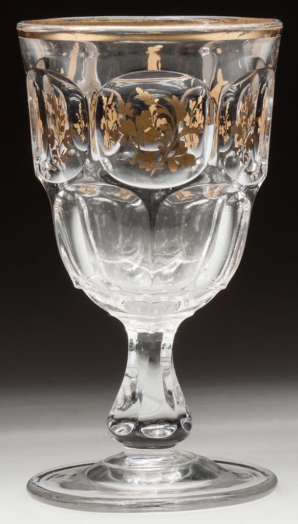 ASHBURTON CHAMPAGNE GLASS: ASHBURTON CHAMPAGNE GLASS, colorless lead glass with gilt-foliate decoration, polished pontil mark, gilt "1333" under base. Probably New England Glass Co. Third quarter 19th century. 5" H. Provenance: