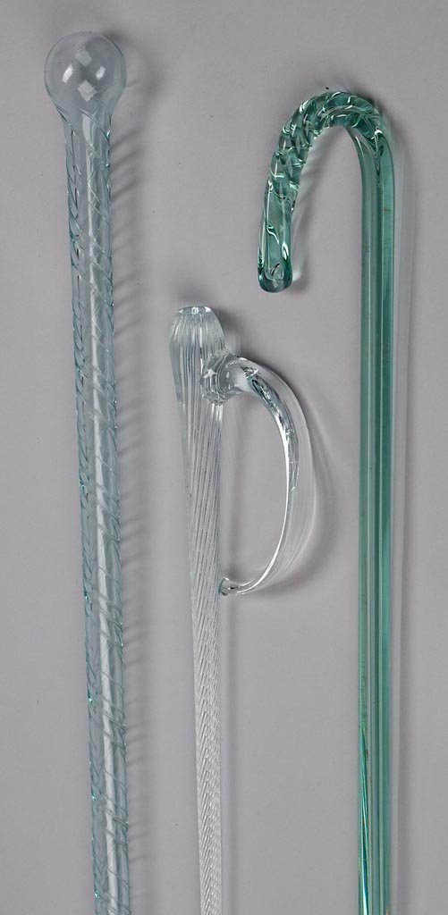 BLOWN-GLASS WHIMSIES, LOT OF THREE: BLOWN-GLASS WHIMSIES, LOT OF THREE, comprising a colorless dagger with ribbed shaft, an aquamarine staff with applied, swirled threads, and a light green cane with heavy ribs. United States. First hal