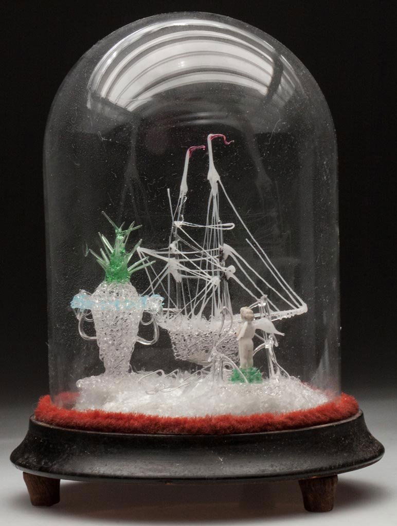 SPUN-GLASS FIGURAL GROUP: SPUN-GLASS FIGURAL GROUP, comprising a fully-rigged clipper ship, double-handle urn and a ceramic "Frozen Charlotte" doll with applied glass wings, all glass-dome display. Fourth quarter 19th century.