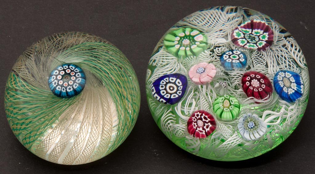PERTHSHIRE MILLEFIORI PAPERWEIGHTS, LOT OF TWO: PERTHSHIRE MILLEFIORI PAPERWEIGHTS, LOT OF TWO, comprising a scattered example with "P/1971" cane, on an upset muslin ground, and a crown-style example with swirled latticinio ribbons supporting the c