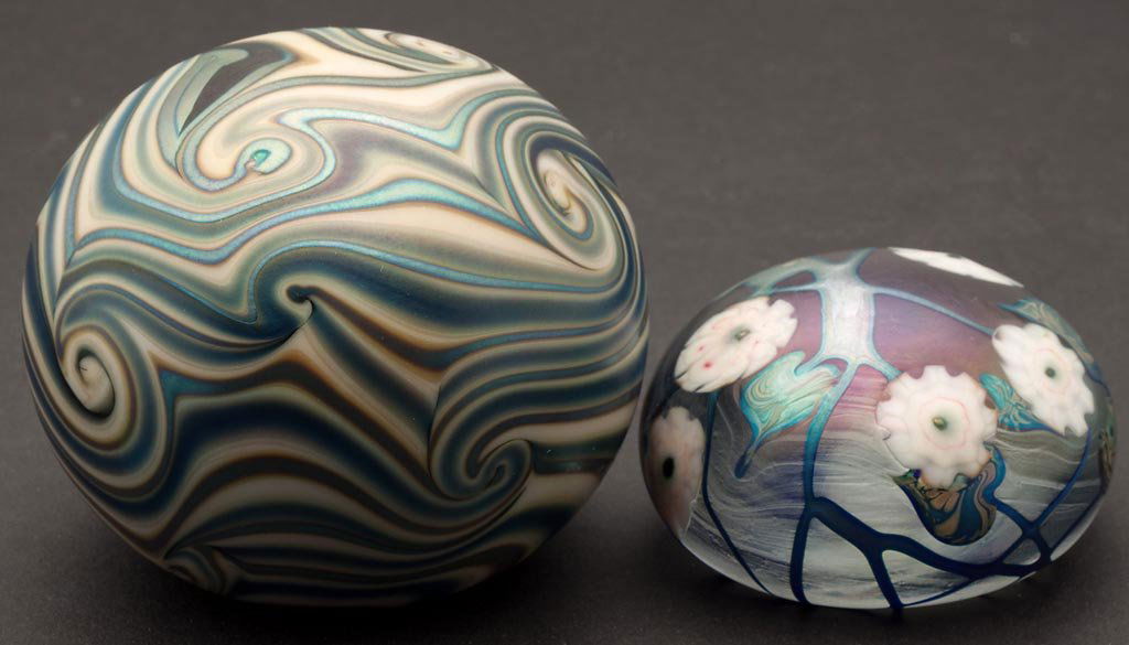 LOTTON STUDIO ART GLASS PAPERWEIGHTS, LOT OF TWO: LOTTON STUDIO ART GLASS PAPERWEIGHTS, LOT OF TWO, iridescent surfaces, comprising a King Tut-style decoration signed "Lotton 1972" around the ground pontil mark, and a floral example signed "David Lot